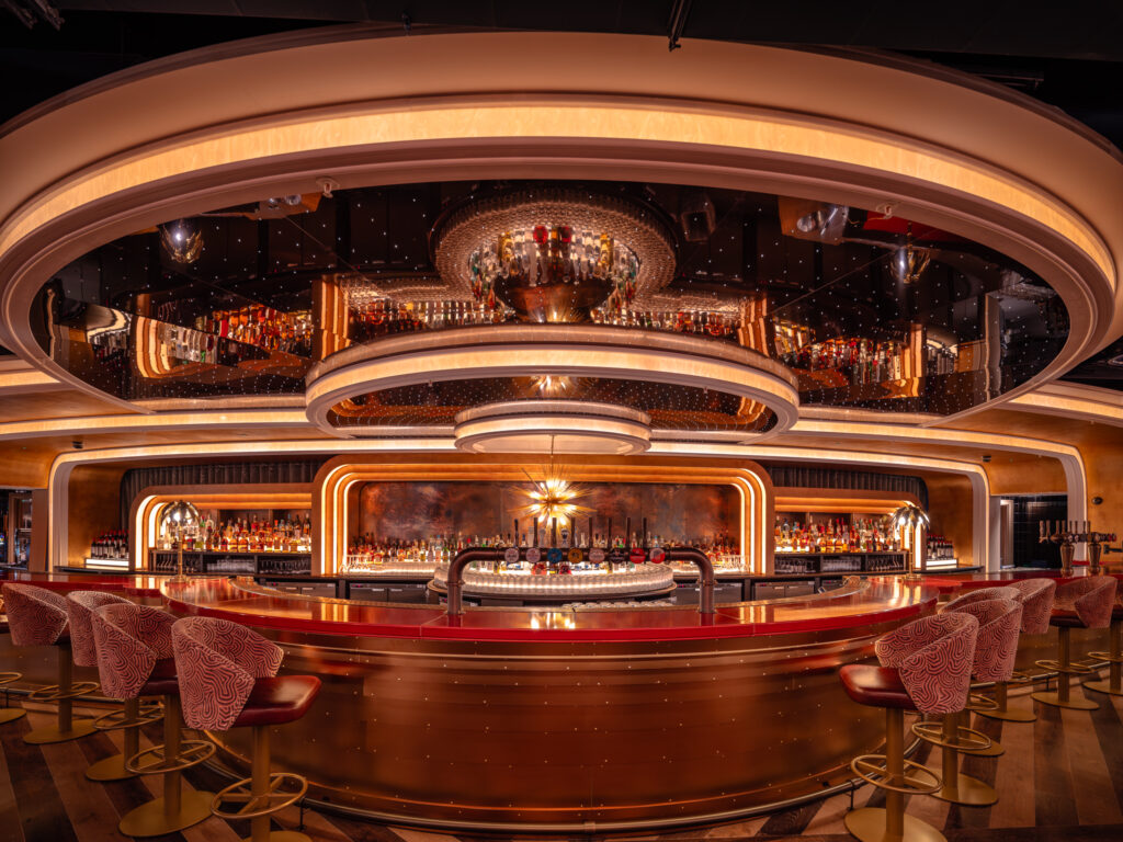 Poolhouse flagship bar at Liverpool Street London featuring a curved illuminated design and immersive competitive socialising interior by Ellis Design Studio