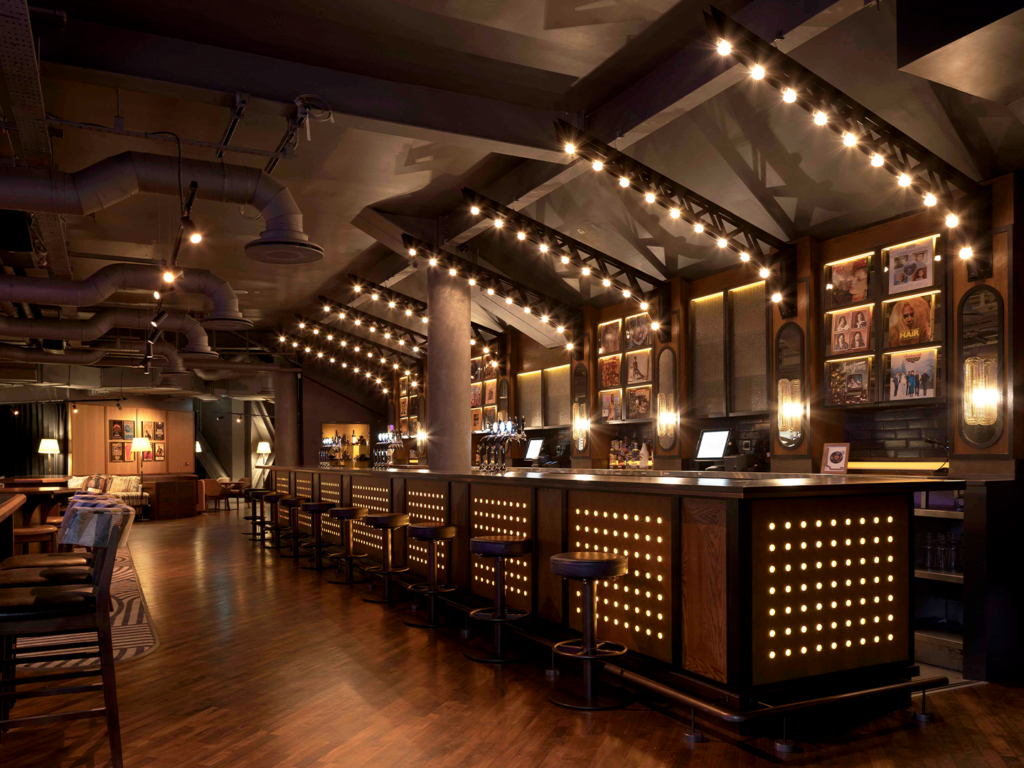 Private members club inside 3Arena Dublin showcasing bespoke interior design by Ellis Design Studio with a custom vintage speaker feature wall, premium lounge seating, and ambient lighting